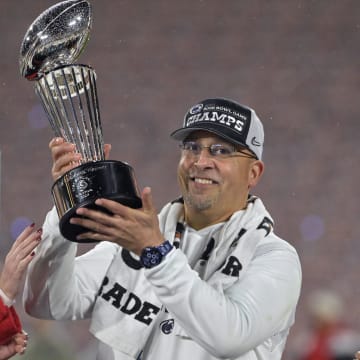 Penn State football coach James Franklin celebrates with the Rose Bowl trophy after the Nittany Lions defeated Utah in the 109th Rose Bowl game. 