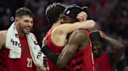 Oct 31, 2025; Portland, Oregon, USA; Portland Trail Blazers forward Jerami Grant (9), right, celebrates with forward Deni Avdija (8) after a game against the Denver Nuggets at Moda Center. Grant scored the game winning free throws. Mandatory Credit: Troy Wayrynen-Imagn Images