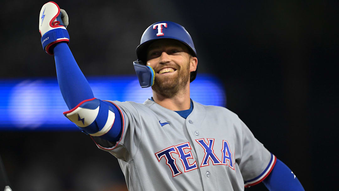 Texas Rangers left fielder Brandon Nimmo (24) reacts towards the dugout after hitting a single during the third inning against the Los Angeles Dodgers at Dodger Stadium. 