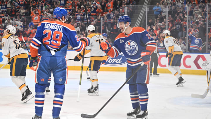 Mar 15, 2026; Edmonton, Alberta, CAN;  Edmonton Oilers center Leon Draisaitl (29) and Oilers left wing Zach Hyman (18) celebrate a goal on Nashville Predators goalie Justus Annunen (29) during the first period at Rogers Place. Mandatory Credit: Walter Tychnowicz-Imagn Images