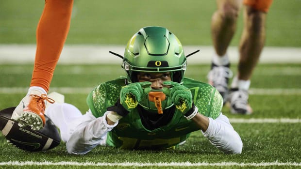 Oregon Ducks wide receiver Tez Johnson (15) makes a sign with his fingers showing how close he was to scoring a touchdown aft