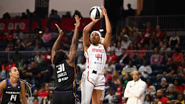 Jun 8, 2025; Washington, District of Columbia, USA; Washington Mystics forward Kiki Iriafen (44) attempts a jump shot in front of Connecticut Sun center Tina Charles (31) during the first quarter at CareFirst Arena. Mandatory Credit: Rafael Suanes-Imagn Images