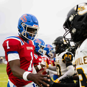 Noxubee County Tigers quarterback Kamario Taylor (1) greets the Starkville high captains before the two teams kicked off the 2024 MHSAA football season on Friday, Aug. 30 in Macon, Miss.