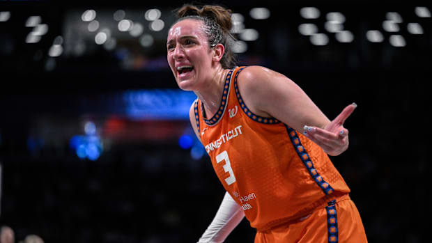 Connecticut Sun guard Marina Mabrey reacts to a call while wearing an orange jersey