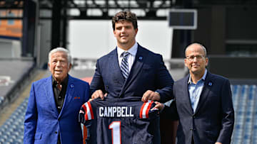 Apr 25, 2025; Foxborough, MA, USA; New England Patriots first round draft pick Will Campbell is presented with a ceremonial first round jersey by team owner Robert Kraft (l) and team president Jonathan Kraft (r) at a press conference on the game field at Gillette Stadium.  Mandatory Credit: Eric Canha-Imagn Images