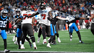 Dec 1, 2024; Charlotte, North Carolina, USA; Tampa Bay Buccaneers running back Bucky Irving (7) scores a touchdown in the fourth quarter at Bank of America Stadium. Mandatory Credit: Bob Donnan-Imagn Images