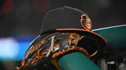 May 8, 2024; Washington, District of Columbia, USA; A Baltimore Orioles hat and glove rest on the dugout rail during a game against the Washington Nationals at Nationals Park.