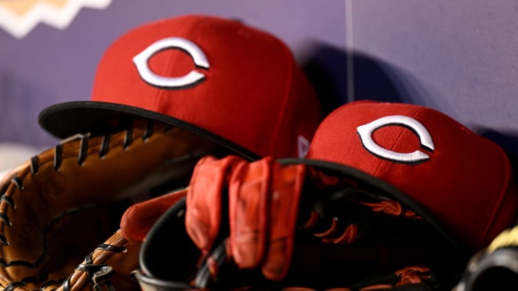 Cincinnati Reds hats and baseball gloves