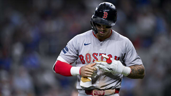 Boston Red Sox left fielder Jarren Duran (16) removes his batting gloves after he strikes out to end the inning against the Texas Rangers during the eighth inning at Globe Life Field. 