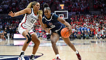 Nov 20, 2024; Storrs, Connecticut, USA; Fairleigh Dickinson Knights forward Teneisia Brown (20) drives to the basket defended by Connecticut Huskies forward Ice Brady (25) during the first half at Harry A. Gampel Pavilion. Mandatory Credit: Mark Smith-Imagn Images
