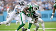 Sep 15, 2024; Nashville, Tennessee, USA;  Tennessee Titans linebacker Kenneth Murray Jr. (56) and linebacker Ernest Jones IV tackle New York Jets running back Breece Hall (20) for a loss during the second half at Nissan Stadium. 