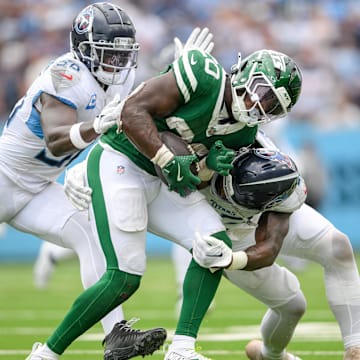 Sep 15, 2024; Nashville, Tennessee, USA;  Tennessee Titans linebacker Kenneth Murray Jr. (56) and linebacker Ernest Jones IV tackle New York Jets running back Breece Hall (20) for a loss during the second half at Nissan Stadium. 