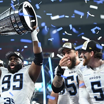 Nov 17, 2024; Vancouver, British Columbia, CAN;  Toronto Argonauts defensive lineman Ralph Holley (99) holds the Grey Cup after the win Winnipeg Blue Bombers at BC Place. Mandatory Credit: Anne-Marie Sorvin-Imagn Images