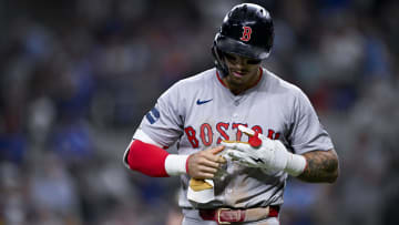 Aug 3, 2024; Arlington, Texas, USA;  Boston Red Sox left fielder Jarren Duran (16) removes his batting gloves after he strikes out to end the inning against the Texas Rangers during the eighth inning at Globe Life Field. Mandatory Credit: Jerome Miron-USA TODAY Sports