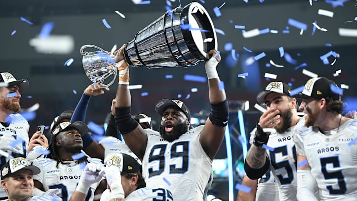 Nov 17, 2024; Vancouver, British Columbia, CAN;  Toronto Argonauts defensive lineman Ralph Holley (99) holds the Grey Cup after the win Winnipeg Blue Bombers at BC Place. Mandatory Credit: Anne-Marie Sorvin-Imagn Images