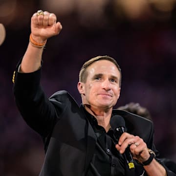 Oct 17, 2024; New Orleans, Louisiana, USA; New Orleans Saints retired quarterback Drew Brees (9) reacts during his hall of fame ceremony at halftime against the Denver Broncos at Caesars Superdome. Mandatory Credit: Matthew Hinton-Imagn Images