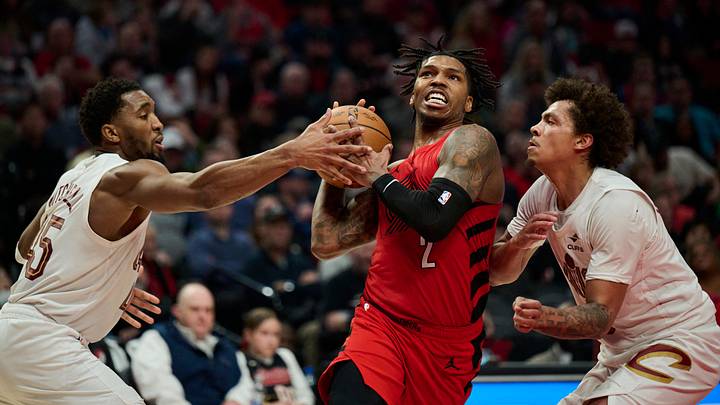 Feb 1, 2026; Portland, Oregon, USA; Portland Trail Blazers guard Caleb Love (2) drives to the basket during the second half against Cleveland Cavaliers guard Donovan Mitchell (45) and guard Craig Porter Jr. (9) at Moda Center. Mandatory Credit: Troy Wayrynen-Imagn Images
