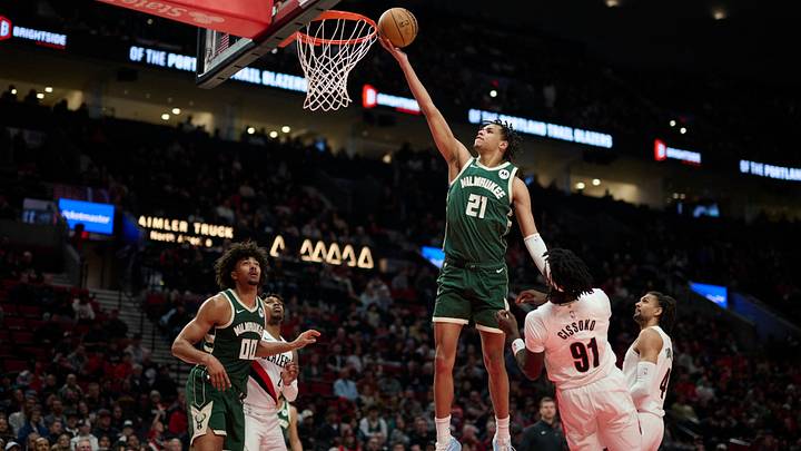 Mar 25, 2026; Portland, Oregon, USA; Milwaukee Bucks forward Ousmane Dieng (21) scores a basket during the second half against Portland Trail Blazers guard Sidy Cissoko (91) at Moda Center. Mandatory Credit: Troy Wayrynen-Imagn Images