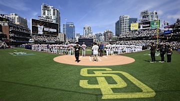 San Diego Padres players stand on the field during the national anthem before a baseball game against the Atlanta Braves at Petco Park on March 27.
