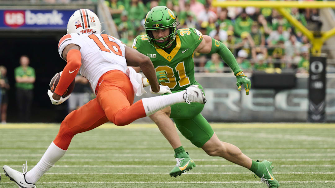 Sep 6, 2025; Eugene, Oregon, USA; Oregon Ducks defensive back Dillon Thieneman (31) runs after Oklahoma State Cowboys wide receiver Christian Fitzpatrick (16) during the first half at Autzen Stadium. Mandatory Credit: Troy Wayrynen-Imagn Images