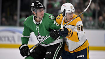 Dec 12, 2024; Dallas, Texas, USA;  Dallas Stars left wing Mason Marchment (27) and Nashville Predators left wing Zachary L'Heureux (68) look for the puck at center ice during the first period at the American Airlines Center. Mandatory Credit: Jerome Miron-Imagn Images