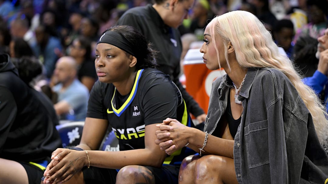 Dallas Wings forward NaLyssa Smith (1) and guard DiJonai Carrington (21) look on from the team bench during the first half against the Washington Mystics at College Park Center. 