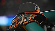 May 8, 2024; Washington, District of Columbia, USA; A Baltimore Orioles hat and glove rest on the dugout rail during a game against the Washington Nationals at Nationals Park. 