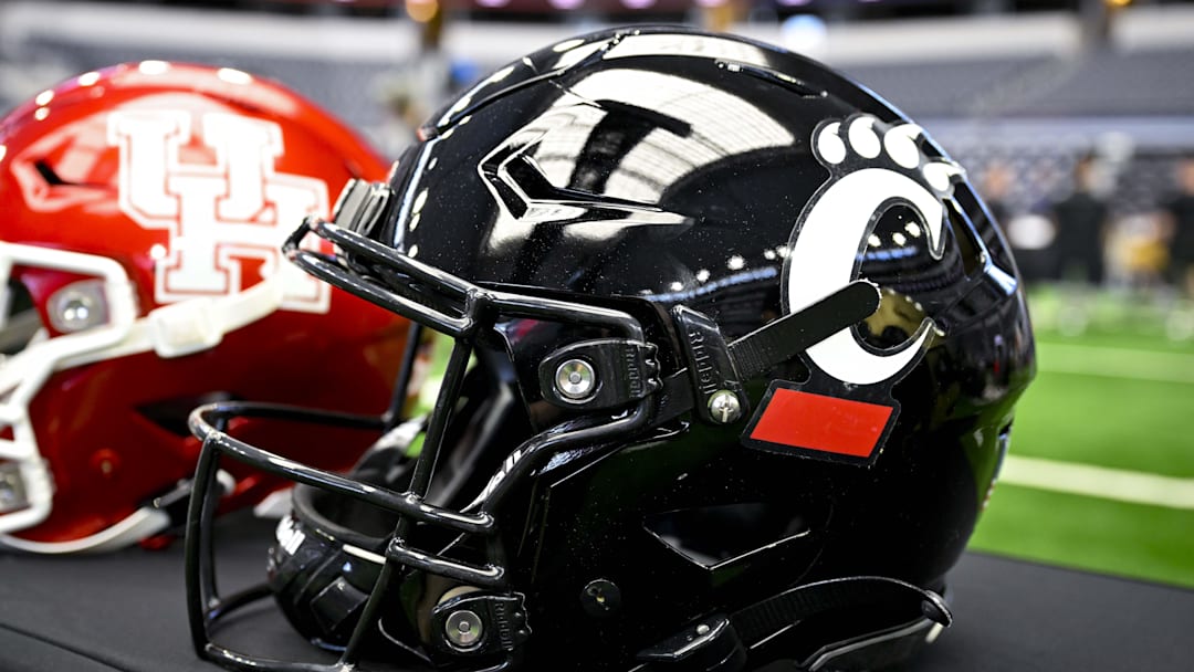 Jul 12, 2023; Arlington, TX, USA; A view of the Cincinnati Bearcats helmet and logo during Big 12 football media day at AT&T Stadium. Mandatory Credit: Jerome Miron-Imagn Images Jul 12, 2023; Arlington, TX, USA; A view of the Cincinnati Bearcats helmet and logo during Big 12 football media day at AT&T Stadium. Mandatory Credit: Jerome Miron-Imagn Images