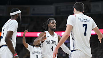 Mar 11, 2025; Indianapolis, IN, USA; Robert Morris Colonials guard Josh Omojafo (4) and Robert Morris Colonials forward Alvaro Folgueiras (7) celebrate after a play during the second half against the Youngstown State Penguins at Corteva Coliseum. Mandatory Credit: Robert Goddin-Imagn Images