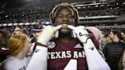 Texas A&M Aggies defensive lineman Shemar Stewart shows off his gold grill smile after the Aggies defeat the LSU Tigers.