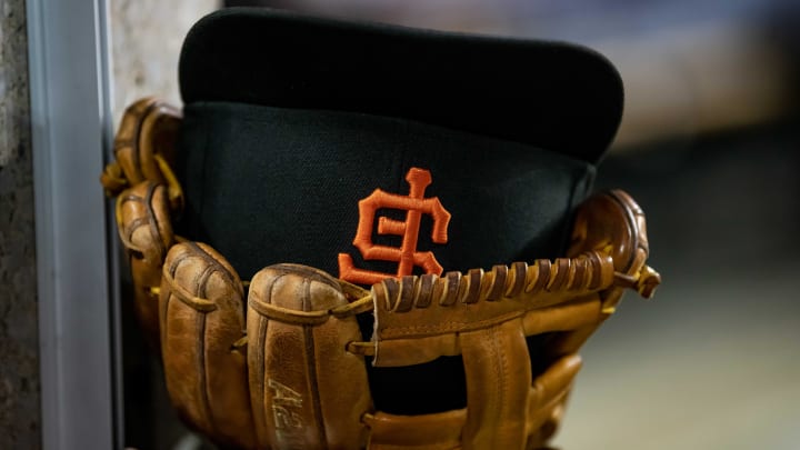 Aug 23, 2022; Detroit, Michigan, USA; The hat and glove of San Francisco Giants third baseman Evan Longoria (10) sits on the edge of the dugout steps during their game against the Detroit Tigers at Comerica Park.