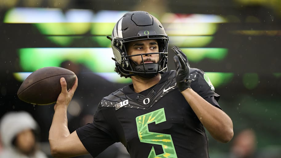 Oregon quarterback Dante Moore sets to throw during warmups.