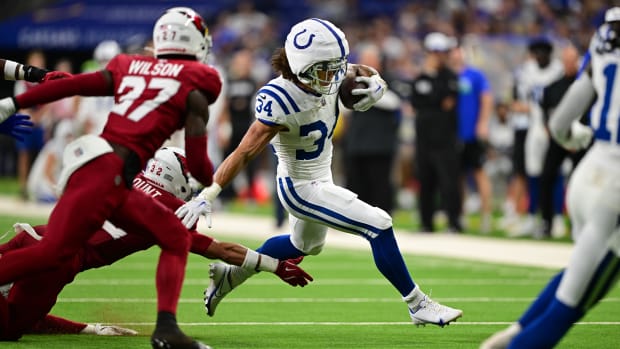 Colts running back Zavier Scott (all-white uniform) makes a run toward the endzone. 