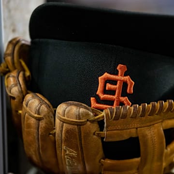 Aug 23, 2022; Detroit, Michigan, USA; The hat and glove of San Francisco Giants third baseman Evan Longoria (10) sits on the edge of the dugout steps during their game against the Detroit Tigers at Comerica Park.