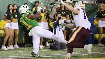 Nov 14, 2025; Eugene, Oregon, USA; Oregon Ducks wide receiver Jeremiah McClellan (11) catches a touchdown pass during the second half against Minnesota Golden Gophers defensive back John Nestor (17) at Autzen Stadium. Mandatory Credit: Troy Wayrynen-Imagn Images