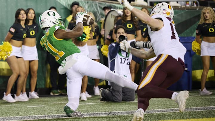 Nov 14, 2025; Eugene, Oregon, USA; Oregon Ducks wide receiver Jeremiah McClellan (11) catches a touchdown pass during the second half against Minnesota Golden Gophers defensive back John Nestor (17) at Autzen Stadium. Mandatory Credit: Troy Wayrynen-Imagn Images