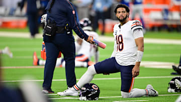 Sep 22, 2024; Indianapolis, Indiana, USA; Chicago Bears quarterback Caleb Williams (18) stretches before the game against the Indianapolis Colts at Lucas Oil Stadium. Mandatory Credit: Marc Lebryk-Imagn Images


