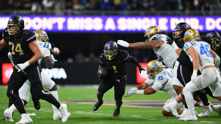 Nov 15, 2024; Seattle, Washington, USA; Washington Huskies running back Jonah Coleman (1) carries the ball against the UCLA Bruins during the second half at Alaska Airlines Field at Husky Stadium. Mandatory Credit: Steven Bisig-Imagn Images