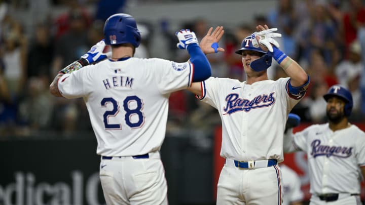 Aug 3, 2024; Arlington, Texas, USA;  Texas Rangers catcher Jonah Heim (28) and third baseman Josh Jung (6) celebrate after Heim hits a three run home run against the Boston Red Sox during the fourth inning at Globe Life Field. Mandatory Credit: Jerome Miron-USA TODAY Sports