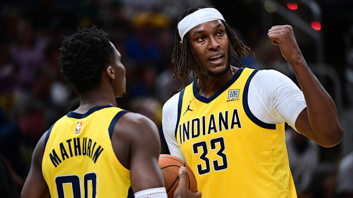 Oct 27, 2024; Indianapolis, Indiana, USA; Indiana Pacers center Myles Turner (33) talks with guard Bennedict Mathurin (00) during the second half of the game against the Philadelphia 76ers at Gainbridge Fieldhouse. Mandatory Credit: Marc Lebryk-Imagn Images