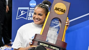 Apr 20, 2024; Fort Worth, TX, USA; LSU Tigers gymnast Haleigh Bryant poses with the championship trophy after the LSU Tigers gymnastics team wins the national championship in the 2024 Womens National Gymnastics Championship at Dickies Arena. Mandatory Credit: Jerome Miron-USA TODAY Sports