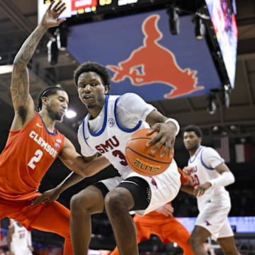 Feb 22, 2025; Dallas, Texas, USA; SMU Mustangs guard Chuck Harris (3) looks to move the ball past Clemson Tigers guard Dillon Hunter (2) during the second half at Moody Coliseum. Jerome Miron-Imagn Images