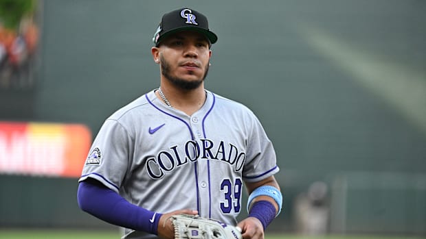 Colorado Rockies second baseman Thairo Estrada looks at the crowd while wearing a gray uniform and black hat