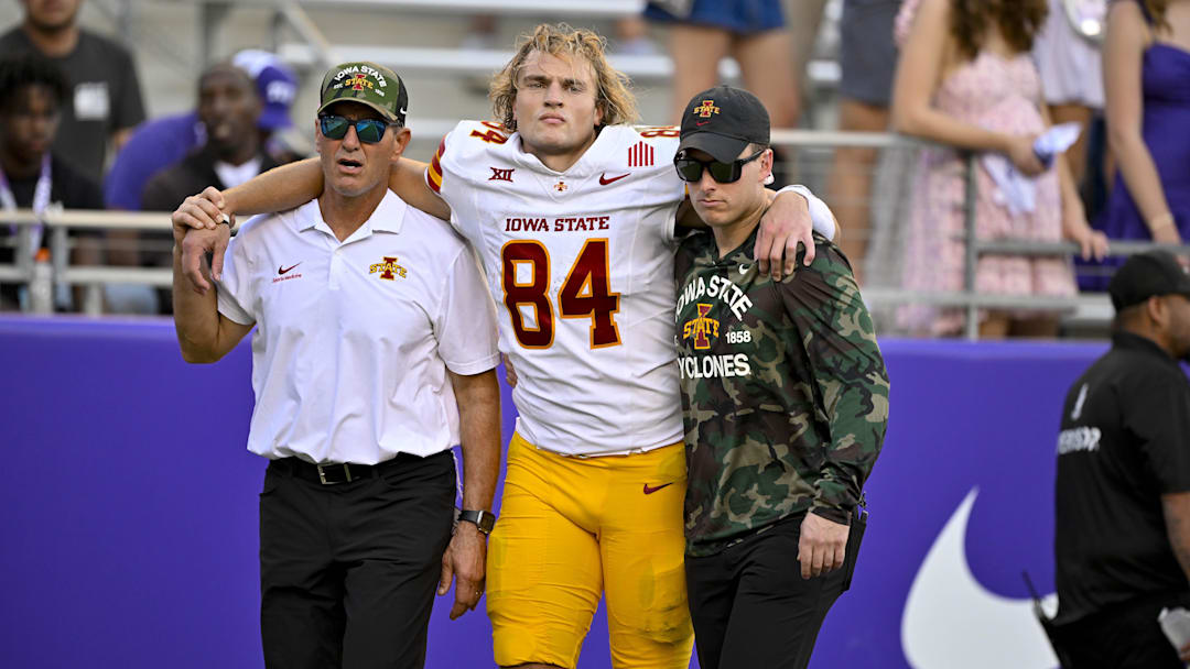 Nov 8, 2025; Fort Worth, Texas, USA; Iowa State Cyclones tight end Gabe Burkle (84) is helped off the field during the first half against the TCU Horned Frogs at Amon G. Carter Stadium. Mandatory Credit: Jerome Miron-Imagn Images