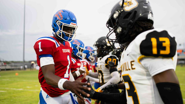 Noxubee County Tigers quarterback Kamario Taylor (1) greets the Starkville high captains