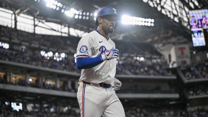 Jul 6, 2024; Arlington, Texas, USA; Texas Rangers second baseman Marcus Semien (2) come off the field after he hits a two run home run to give the Rangers the lead over the Tampa Bay Rays during the seventh inning at Globe Life Field. 