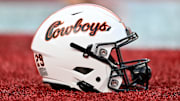 Nov 18, 2023; Houston, Texas, USA; A detailed view of an Oklahoma State Cowboys helmet on the sideline of the game against the Houston Cougars at TDECU Stadium. Mandatory Credit: Maria Lysaker-Imagn Images