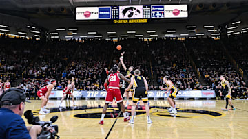 Jan 11, 2025; Iowa City, Iowa, USA; Iowa Hawkeyes forward Owen Freeman (32) and Indiana Hoosiers center Oumar Ballo (11) battle for the opening tipoff between during the first half at Carver-Hawkeye Arena. Mandatory Credit: Jeffrey Becker-Imagn Images