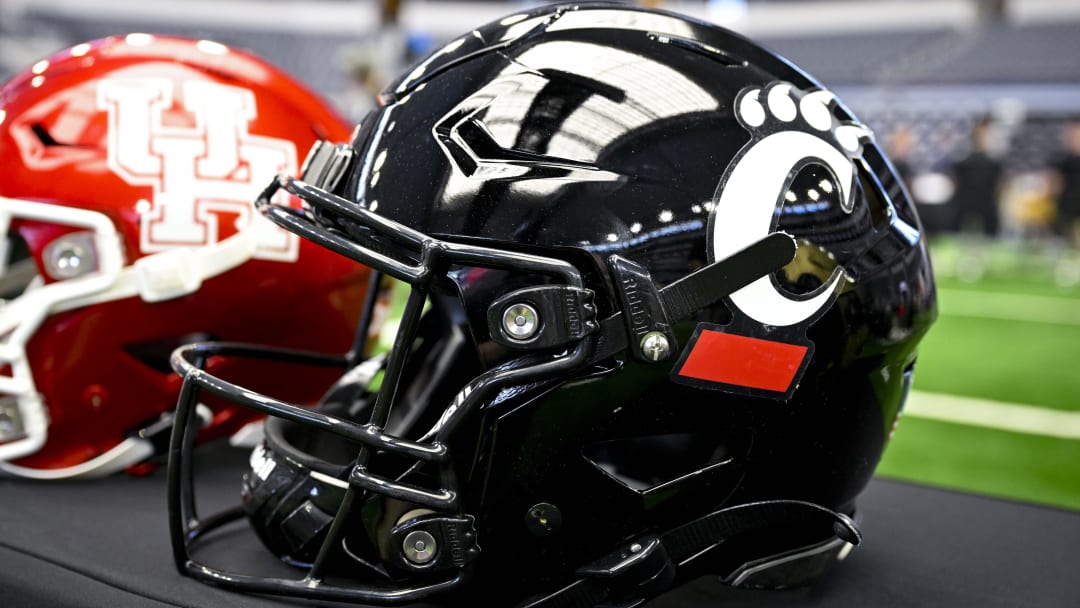 Jul 12, 2023; Arlington, TX, USA; A view of the Cincinnati Bearcats helmet and logo during Big 12 football media day at AT&T Stadium. Mandatory Credit: Jerome Miron-USA TODAY Sports Jul 12, 2023; Arlington, TX, USA; A view of the Cincinnati Bearcats helmet and logo during Big 12 football media day at AT&T Stadium. Mandatory Credit: Jerome Miron-USA TODAY Sports