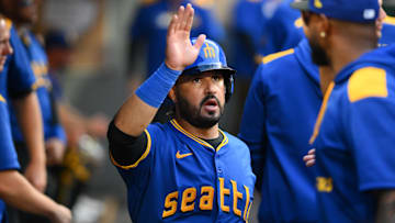 Jul 31, 2025; Seattle, Washington, USA; Seattle Mariners third baseman Eugenio Suarez (28) celebrates in the dugout after scoring a run against the Texas Rangers during the fourth inning at T-Mobile Park. Mandatory Credit: Steven Bisig-Imagn Images